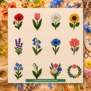 May include: A cross-stitch sampler on cream fabric featuring 12 distinct floral motifs, including a red poppy, pink tulip, white daisy, yellow sunflower, purple lavender, blue bellflowers, and a small wreath, with the text 12 BEGINNER-FRIENDLY MINI PATTERNS.