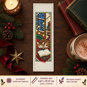 May include: A rectangular cross-stitch bookmark featuring a brown tabby cat sleeping on a red and green plaid blanket next to an open book. The scene includes a window with a snowy landscape, string lights, and books. Finished size is 2.63 x 7.63 inches.