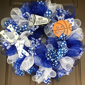May include: A blue and white wreath with a basketball, a megaphone with the text "Go Team!" and the letters "UK" with the text "Cats" on each letter.