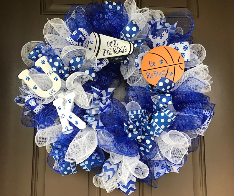May include: A blue and white wreath with a basketball, a megaphone with the text "Go Team!" and the letters "UK" with the text "Cats" on each letter.