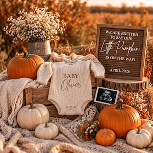 May include: A cream-colored knit baby bodysuit with the text Baby Oliver, surrounded by orange and white pumpkins, a metal pitcher with white flowers, a brown letter board reading We are excited to say our Little Pumpkin is on the way! April 2026, and an ultrasound photo.