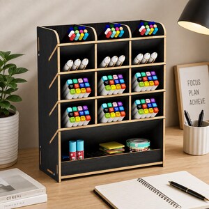 May include: A black wooden desk organizer with multiple compartments filled with colorful markers, pens, and stationery supplies. The unit features three top slots, three rows of three cubbies, and a wide bottom shelf for small items.