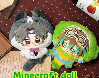 May include: Two plush dolls featuring stylised anime-inspired faces. The left doll has grey and white fur, a purple headband, and a yin-yang symbol on its chest. The right doll is green with brown hair, wearing yellow and white goggles.