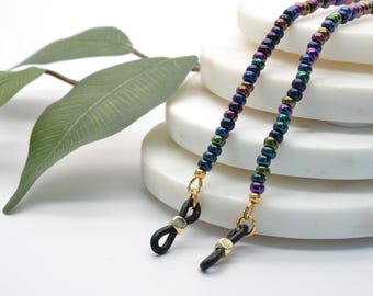 Beaded eyeglasses chain in gold touched shades of purple, green and blue jewels