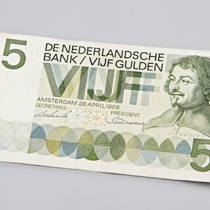 May include: A vintage five Dutch guilder banknote. The bill features the text "VIJF" and "DE NEDERLANDSCHE BANK" along with a portrait of a man. The number "5" is prominently displayed in green.