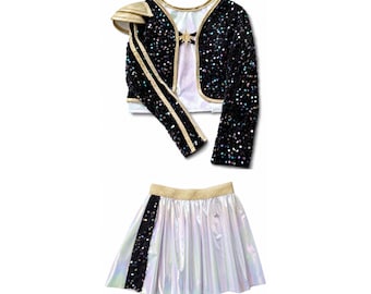 May include: A two-piece outfit consisting of a black long-sleeve bolero jacket covered in iridescent sequins with gold trim and a shoulder accent, paired with a white iridescent pleated skirt featuring a vertical black sequin stripe.