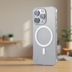 May include: A clear, frosted smartphone case featuring a white circular MagSafe magnetic ring and a small white vertical alignment tab on the back. The case has a raised camera cutout with three circular lens openings and a flash sensor cutout.