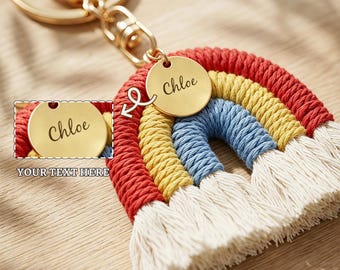 May include: A macrame rainbow keychain featuring red, yellow, blue, and off-white cord layers with a gold-toned metal keyring and a circular gold-toned charm engraved with the name Chloe. The design includes a small inset showing the charm.