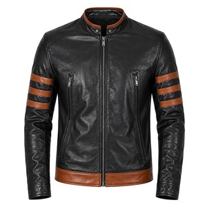 May include: A black leather jacket featuring a stand-up collar with brown trim, a central zip closure, and two vertical zipped chest pockets. The sleeves are accented with three horizontal brown stripes, and the hem has a brown leather band.