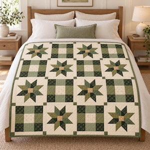 May include: A quilt featuring a repeating pattern of eight-pointed stars and solid squares in shades of sage green, forest green, and cream. The design is composed of geometric fabric blocks arranged in a grid, with a cream-colored border.