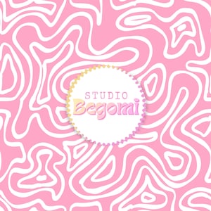 May include: A circular white emblem with a scalloped edge centered on a pink background featuring a white wavy line pattern. The emblem displays the text STUDIO in a simple font above the word Begomi in a larger, stylized pink and yellow font.