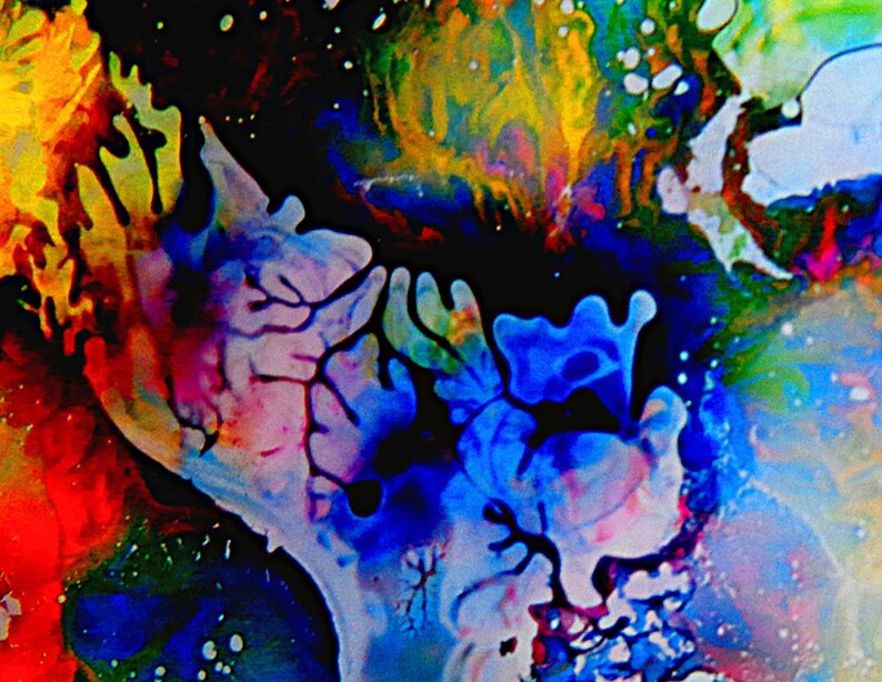 May include: Abstract art painting with vibrant colors, including blue, red, yellow, green, and white. The paint appears to be swirling and flowing, creating a dynamic and energetic composition.