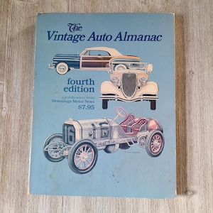 May include: The Vintage Auto Almanac, fourth edition, featuring illustrations of classic cars. The cover is light blue with the title in dark blue and images of vintage vehicles. Published by Hemmings Motor News.