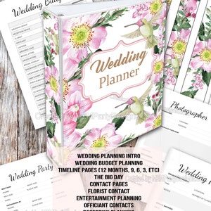May include: A pink and green floral design wedding planner binder with a hummingbird on the cover. The text "Wedding Planner" is in gold lettering. The binder includes 100 printable pages for wedding planning, including a budget planner, timeline pages, contact pages, vendor pages, guest list, and table seating.