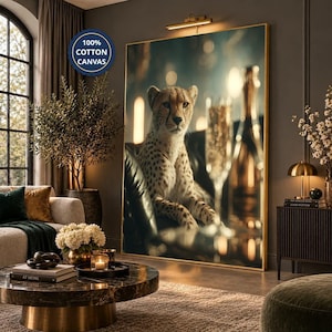 May include: A large rectangular wall art print featuring a cheetah sitting on a dark leather surface next to a champagne flute and bottle. The artwork is framed in gold and includes a circular blue badge stating 100% COTTON CANVAS.