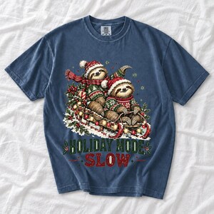 Two sloths in ugly sweaters riding a sled with lights and the text Holiday Mode: Slow