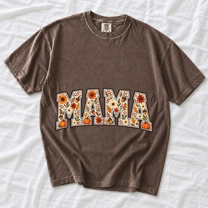 Arched varsity word MAMA filled with fall flowers and acorns in cream, rust and mustard