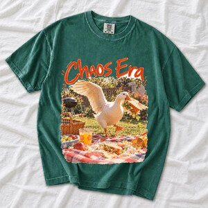 Goose stealing a sandwich from a picnic blanket, 90s film photo style, text "Chaos Era"