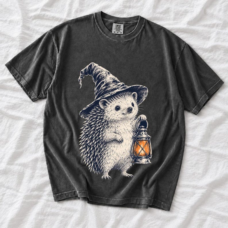 Etched pen illustration of a hedgehog in a witch hat holding a lantern, bone white with orange accent