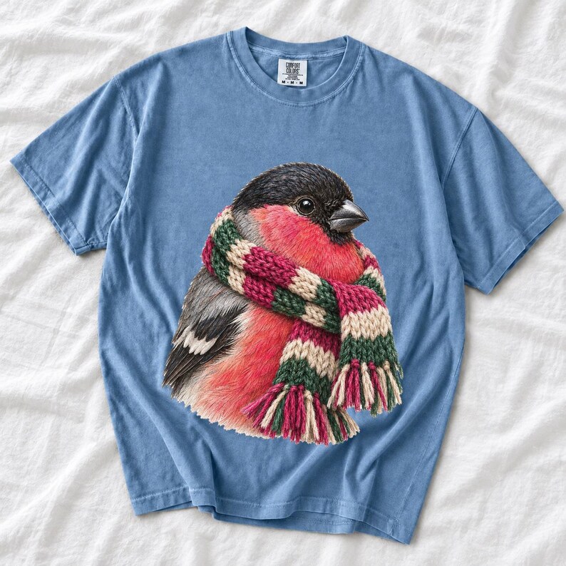 Colored-pencil bullfinch bird wrapped in a chunky striped knit scarf, cozy winter birdwatcher t-shirt art