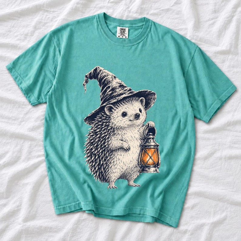 Etched pen illustration of a hedgehog in a witch hat holding a lantern, bone white with orange accent
