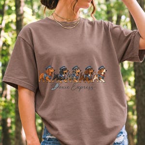 Illustrated dachshunds in conductor hats lined up like a train, text Doxie Express