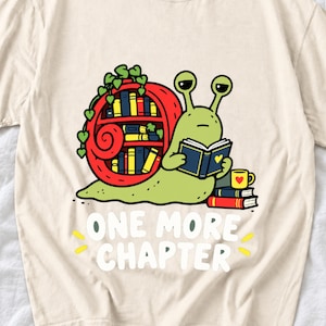 Cartoon snail reading a book with a bookshelf shell and the text One More Chapter