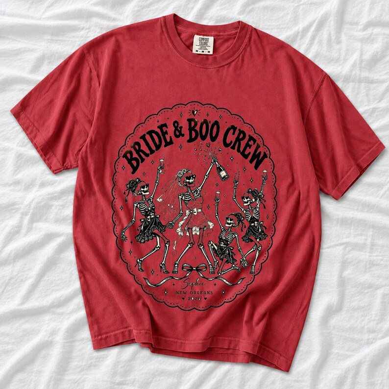 Skeleton bride popping champagne with cheering skeleton bridesmaids and the text Bride & Boo Crew