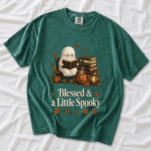 Cute ghost with glasses reading a Bible with a candle and mug, text "Blessed & a Little Spooky", retro fall illustration