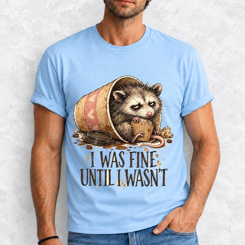 Tired opossum inside a tipped paper coffee cup with the text "I Was Fine Until I Wasn't", sepia watercolor sketch