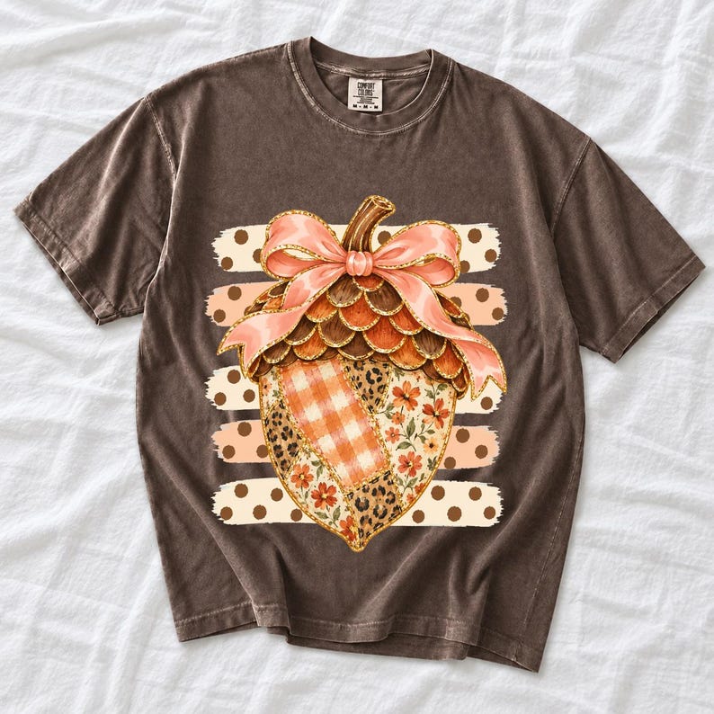 Giant patchwork acorn with a pink satin bow made of plaid, leopard and floral fabric on polka-dot stripes