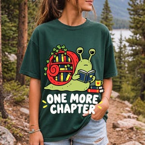 Cartoon snail reading a book with a bookshelf shell and the text One More Chapter