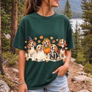Five watercolor beagles in witch, ghost, pumpkin, skeleton and vampire costumes with floating autumn leaves