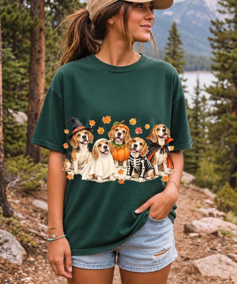 Five watercolor beagles in witch, ghost, pumpkin, skeleton and vampire costumes with floating autumn leaves
