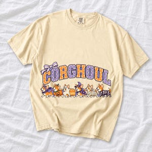 Six corgis in Halloween costumes walking under the arched word CORGHOUL, lavender and orange polka-dot varsity style