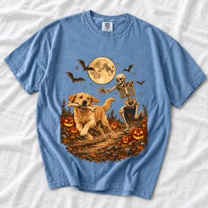 A skeleton chasing a golden labrador that stole its arm bone under a full moon with jack o lanterns and bats