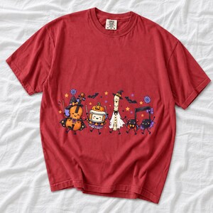 Kawaii violin, drum, recorder and notes with faces in Halloween costumes, pastel purple and orange
