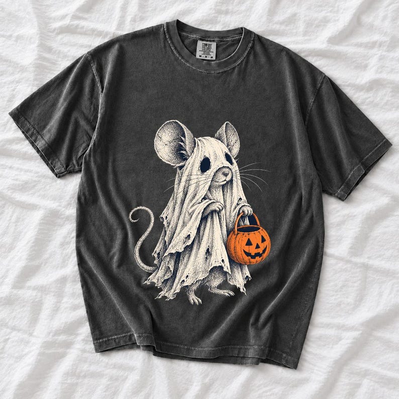 Etched pen illustration of a small mouse in a sheet ghost costume holding a candy bucket, bone white with orange accent