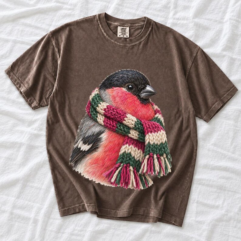 Colored-pencil bullfinch bird wrapped in a chunky striped knit scarf, cozy winter birdwatcher t-shirt art