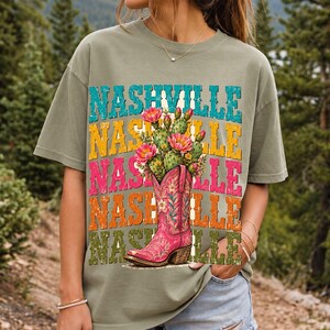 Pink embroidered cowboy boot with blooming cactus over a five-line stacked NASHVILLE word in retro colors