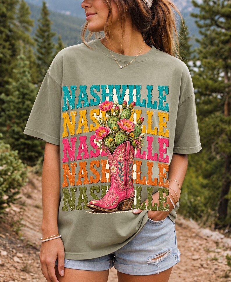 Pink embroidered cowboy boot with blooming cactus over a five-line stacked NASHVILLE word in retro colors