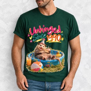 Opossum in party hat in a kiddie pool with cake, 90s film photo style, text "Unhinged Since 1990"