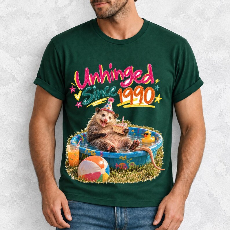 Opossum in party hat in a kiddie pool with cake, 90s film photo style, text "Unhinged Since 1990"