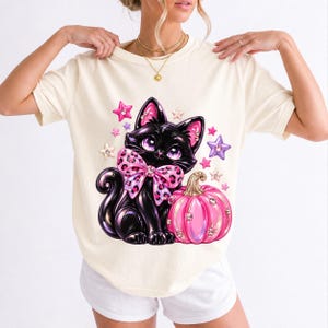 Puffy 3D black cat with a leopard bow beside a glossy pumpkin and stars in coquette style