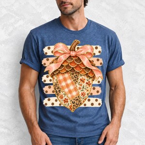 Giant patchwork acorn with a pink satin bow made of plaid, leopard and floral fabric on polka-dot stripes