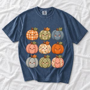 Grid of smiling pumpkins sewn from gingham, floral and corduroy patchwork fabric in autumn colors