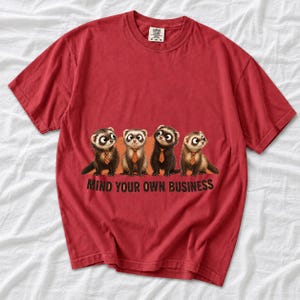 Four ferrets in tiny ties in a row with the text "Mind Your Own Business"