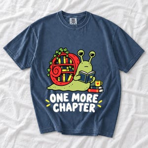 Cartoon snail reading a book with a bookshelf shell and the text One More Chapter