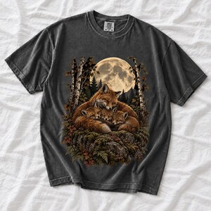 Fox family curled on a rock under a huge full moon among birch trees, dark realistic woodland illustration