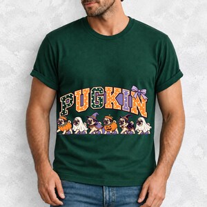 Six pugs in pumpkin, ghost and witch costumes under the arched word PUGKIN, lavender and orange polka-dot varsity style